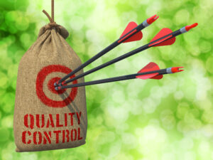 Quality Control - Three Arrows Hit in Red Target on a Hanging Sack on Green Bokeh Background.